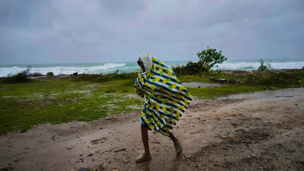 A man walks in the rain before the arrival of Hurricane Melissa in Canizo, a village in Santiago de Cuba. Photo: Ramon Espinosa/AP/dpa