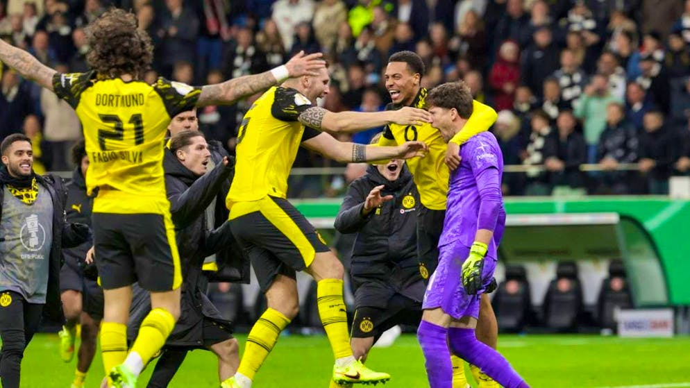 The BVB players hug their goalie Gregor Kobel after the penalty thriller