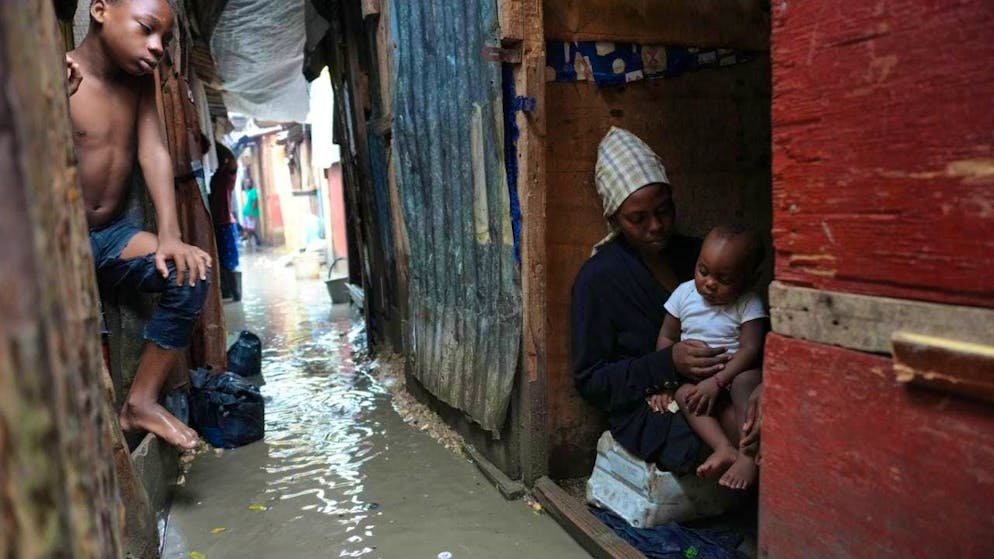 People stay in a flooded emergency shelter for families in Haiti during the passage of Hurricane Melissa. Photo: Odelyn Joseph/AP/dpa