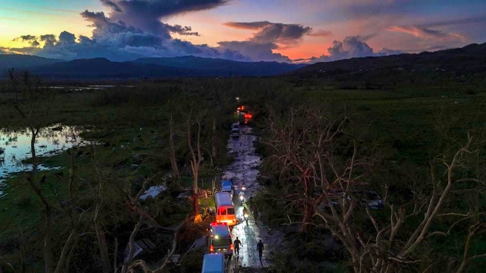 A convoy with relief supplies for Black River, which was hit by Hurricane Melissa, drives through Holland Bamboo, where fallen trees and debris are partially blocking the road. Photo: Matias Delacroix/AP/dpa