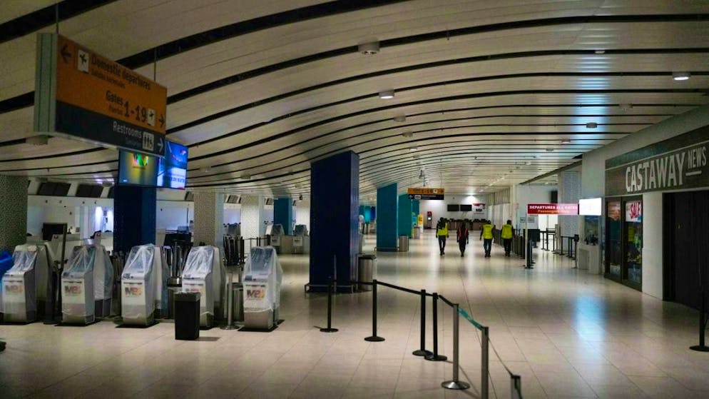 Workers walk through Sangster International Airport in Montego Bay. Photo: Matias Delacroix/AP/dpa