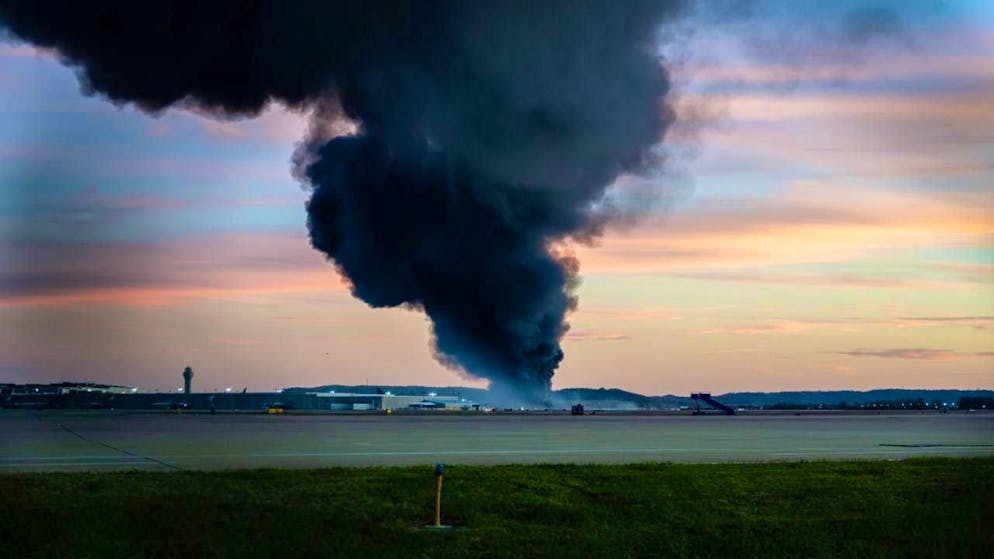 A cloud of smoke rises from the crash site of a UPS cargo plane at Louisville Muhammad Ali International Airport. Photo: Jon Cherry/AP/dpa
