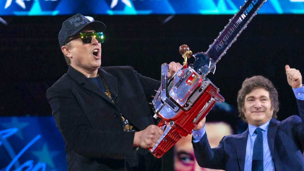 Tesla CEO Elon Musk - shown here with a chainsaw presented to him by Argentinian President Javier Milei (right) - is already the richest person in the world. (February 20, 2025)