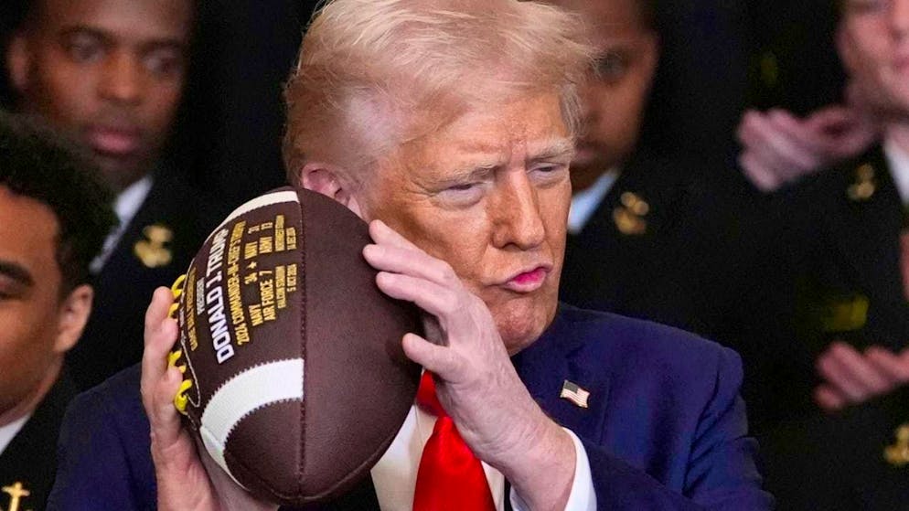 ARCHIVE - US President Donald Trump holds a football in his hand. Photo: Alex Brandon/AP/dpa/Archive image