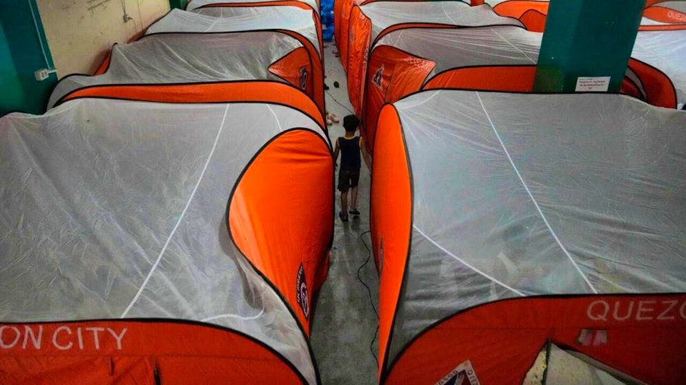 A boy walks among tents at an evacuation center as Typhoon Fung-wong makes landfall in Quezon City, Philippines. Photo: Aaron Favila/AP/dpa