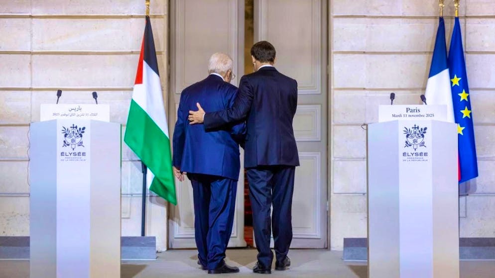 French President Emmanuel Macron, right, leaves the Elysee Palace in Paris with Palestinian President Mahmoud Abbas after a joint statement. Photo: Christophe Petit Tesson/EPA Pool via AP/dpa