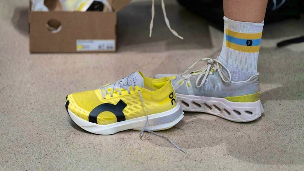 Members of the On Running Club pick up sports shoes for a trail. (archive image)