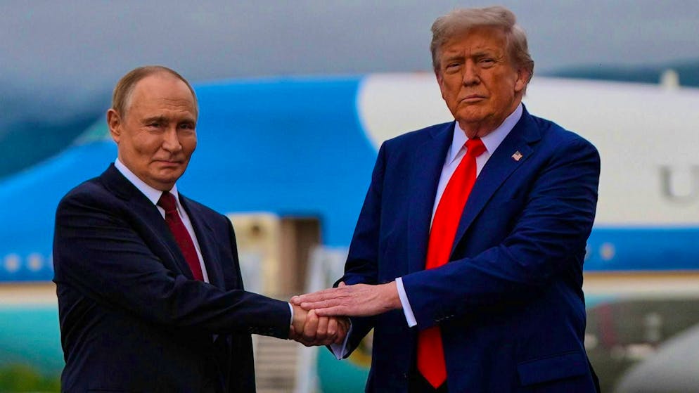 Hand in hand: Vladimir Putin and Donald Trump in Alaska in August.