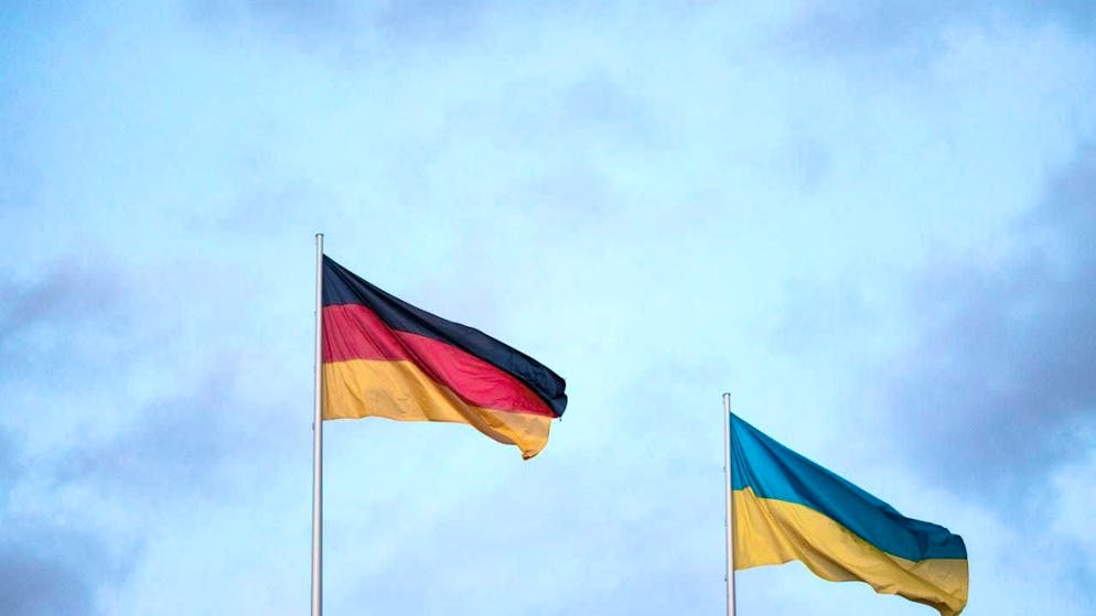 ARCHIVE - A German (l) and a Ukrainian flag waving in the wind. Photo: Hannes P. Albert/dpa
