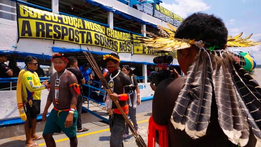Climate activists take part in a People's Summit event at Guajara Bay in Belem, where the COP30 world climate conference is taking place. The People's Summit brings together over 1,200 environmental and climate organizations and networks from Brazil and abroad. Photo: Tânia Rêgo/Agencia Brazil/dpa - ATTENTION: For editorial use only and only with full attribution of the above credit