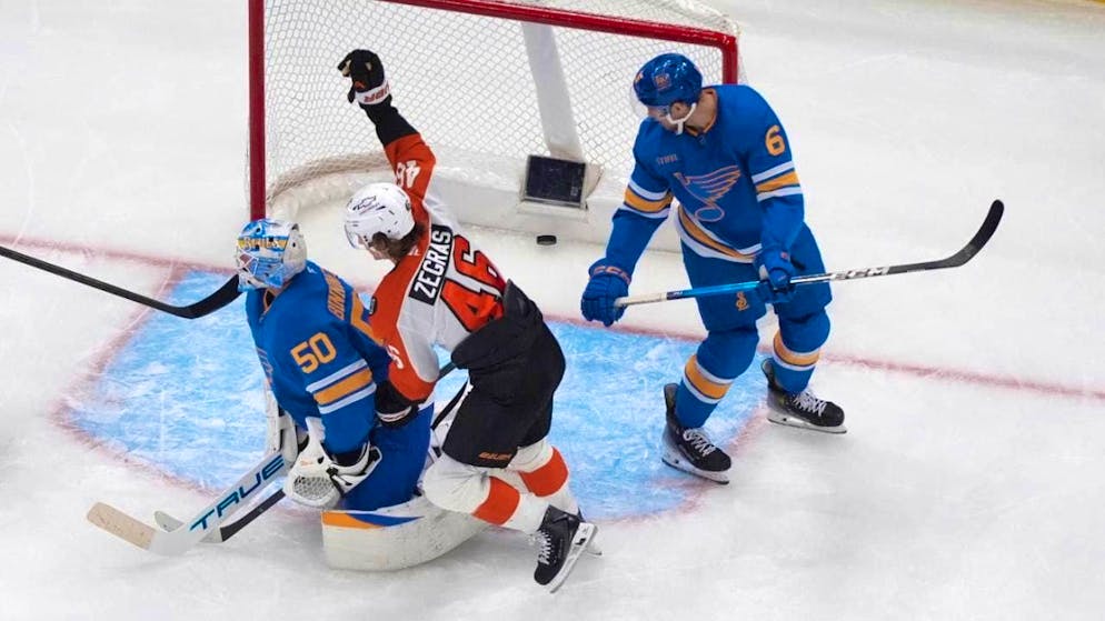 Philadelphia's Trevor Zegras (center) celebrates his goal to tie the game 3-3 away against the St. Louis Blues in the middle period