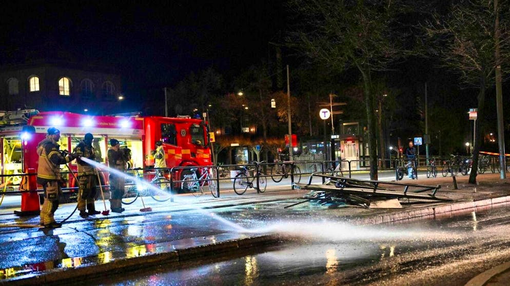 Firefighters spray water at the scene of an accident after a bus crashed into a bus stop. Photo: Henrik Montgomery/TT News Agency/AP/dpa - ATTENTION: For editorial use only and only with full attribution to the above credit