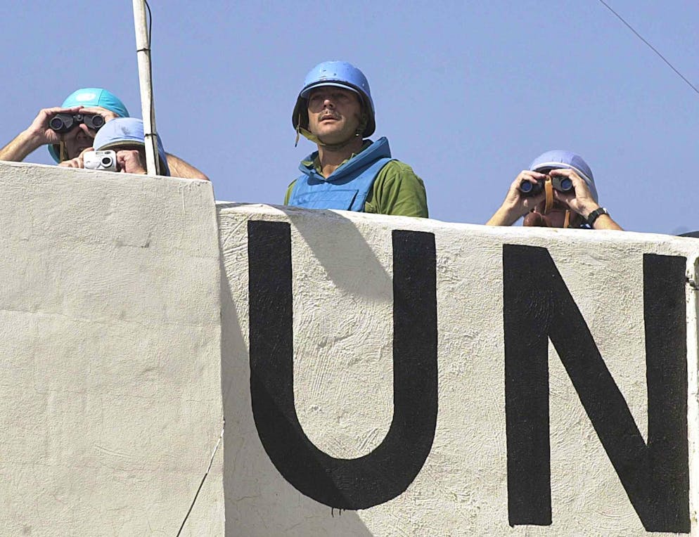 U.N. peacekeepers observe the exchange of shelling between Hezbollah guerrillas and Israeli forces at the Lebanese southern village of Khiam on Wednesday April 10, 2002. Guerrillas attacked several Israeli posts in Chebaa Farms, and Israeli forces retaliated with shelling and air raids. (AP Photo/Hussein Malla)