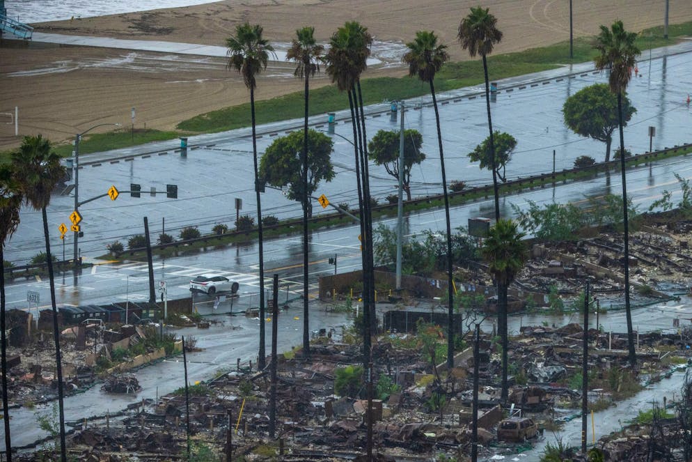 Rain comes down on the Palisades Fire zone on Saturday, Nov. 15, 2025, in the Pacific Palisades section of Los Angeles. (AP Photo/Ethan Swope)