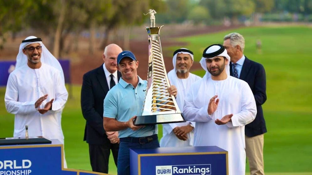 Rory McIlroy poses with the trophy