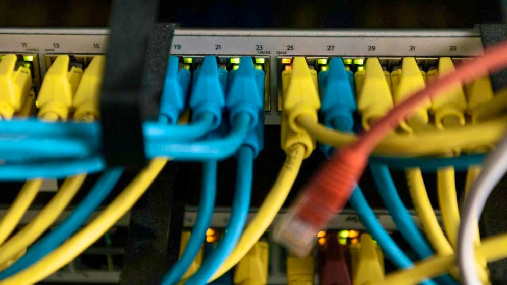 A switch with yellow and blue network cables at Wisekey's premises in Geneva (archive image)