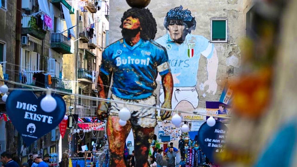 ARCHIVE - The "Largo Maradona" in the Quartieri Spagnoli with the famous mural and a sculpture depicting Diego Armando Maradona is a magnet for soccer fans and tourists. Photo: Arne Dedert/dpa