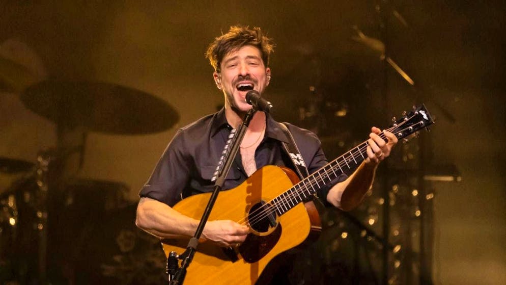 Marcus Mumford, lead singer of the British folk-rock band Mumford & Sons on stage at the Hallenstadion in Zurich.