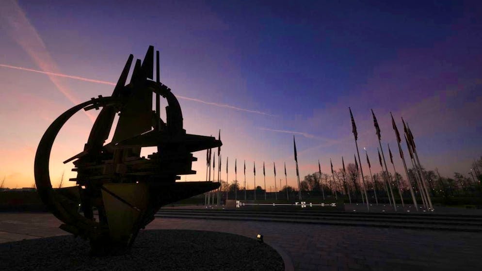ARCHIVE - The sun rises over the sculpture with the NATO star in front of the alliance's headquarters. Photo: Olivier Matthys/AP/dpa