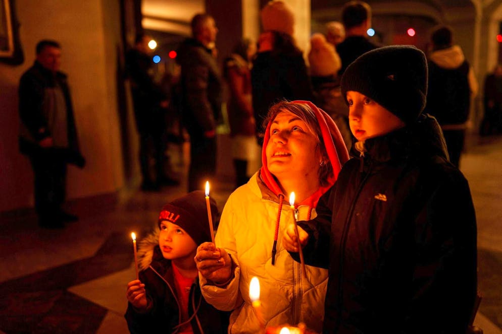 Praying family in the Church of St. Andrew the Apostle.