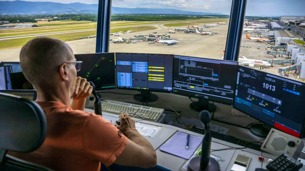 An air traffic controller from Skyguide civil air traffic control in the tower at Geneva Airport. (theme picture)