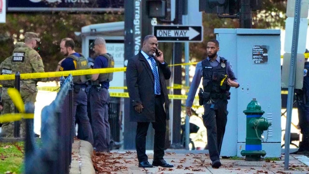 Emergency personnel gather near the site where National Guard members were hit by gunfire near the White House. Photo: Mark Schiefelbein/AP/dpa