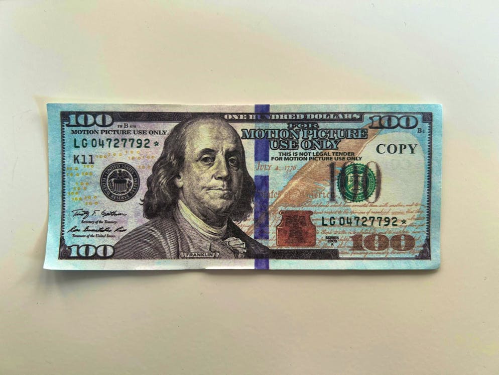 This is what forbidden counterfeit money looks like. The imprints "For Motion Picture Use Only" and "Copy" are barely legible on this 100-dollar note.