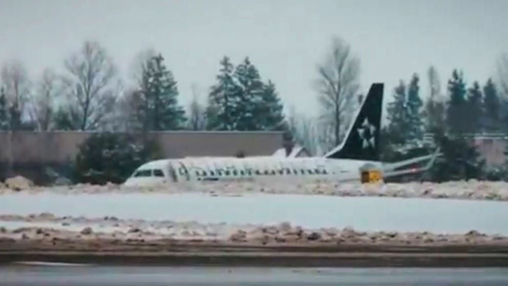 Video shows mishap. Passenger jet skids off the runway and gets stuck in the snow