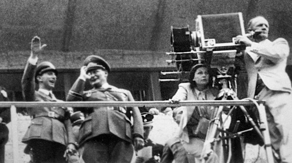 In this picture from Leni Riefenstahl's estate, the artist can be seen (with the camera) on a grandstand with Joseph Goebbels and Hermann Göring during the shooting of her film "Olympia" in 1936.