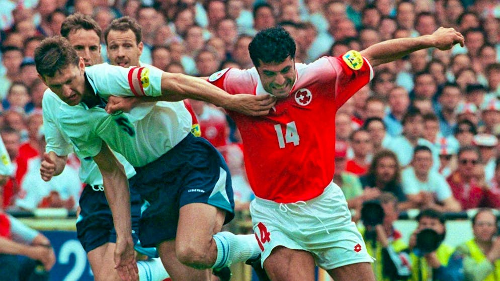 England captain Tony Adams (left) battles with Switzerland's Kubilay Türkyilmaz in the opening match of Euro 96.