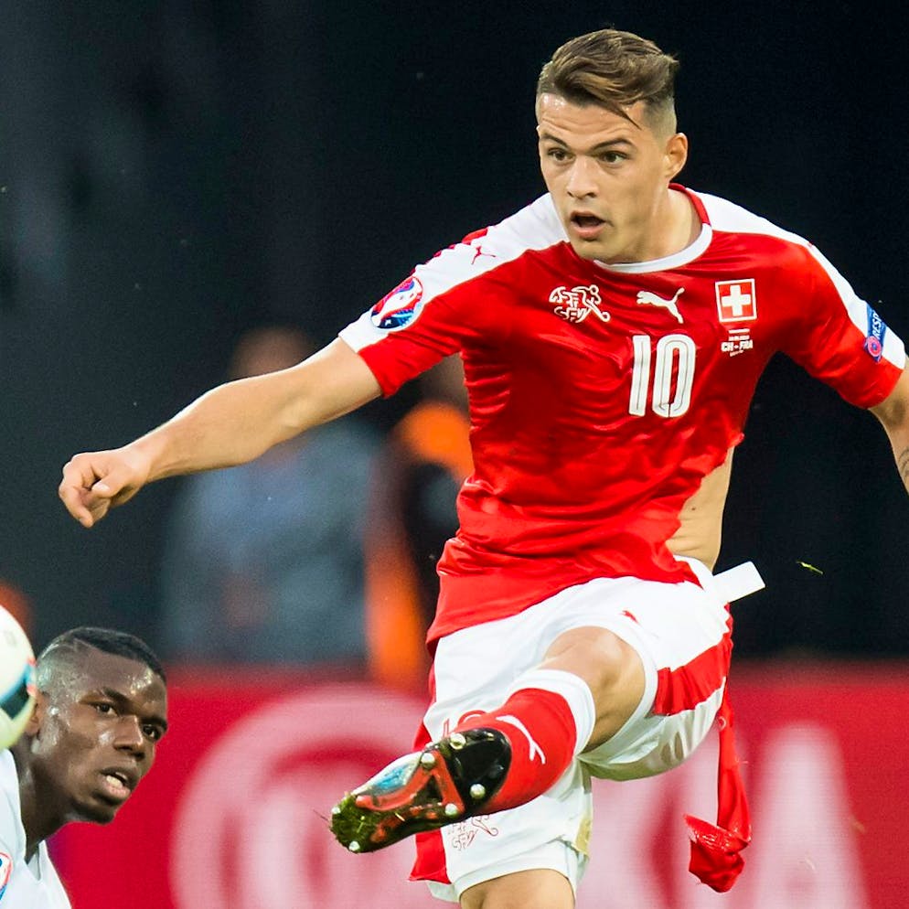 France's midfielder Paul Pogba, left, fights for the ball with Swiss midfielder Granit Xhaka, right, during the UEFA EURO 2016 group A preliminary round soccer match between Switzerland and France, at the Pierre Mauroy stadium, in Villeneuve-d'Ascq near Lille, France, Sunday, June 19, 2016. (KEYSTONE/Jean-Christophe Bott)