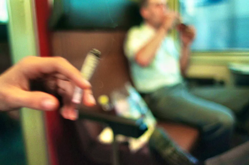 20 years of the smoking ban on SBB trains. It wasn't just normal cigarettes that filled the compartments: a young person smokes a joint on a train journey.