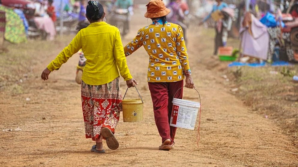 Evacuees carry water as they seek refuge in Chonkal after fleeing fighting between Thailand and Cambodia over territorial claims. Photo: Heng Sinith/AP/dpa