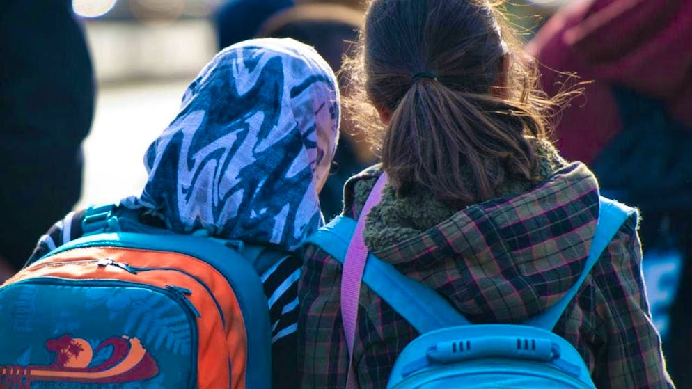 ARCHIVE - A girl with a headscarf stands next to a girl without a headscarf (archive photo). Photo: Daniel Bockwoldt/dpa