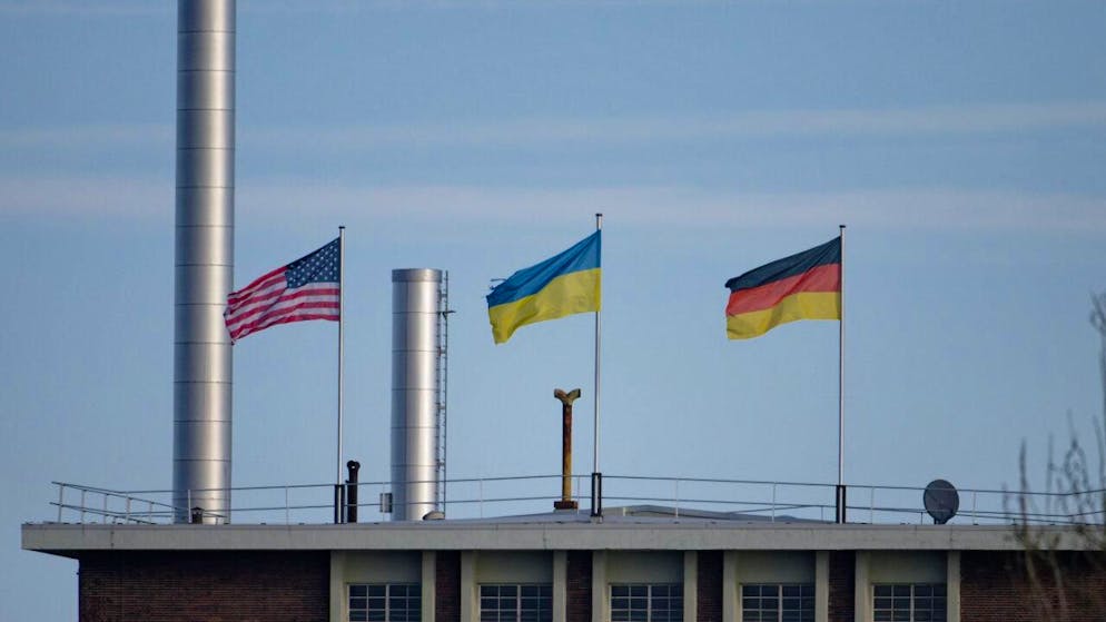 ARCHIV - Die Flaggen der USA (l-r), der Ukraine und der Bundesrepublik Deutschland wehen über dem Dach eines Gebäudes der Fordwerke. Foto: Henning Kaiser/dpa