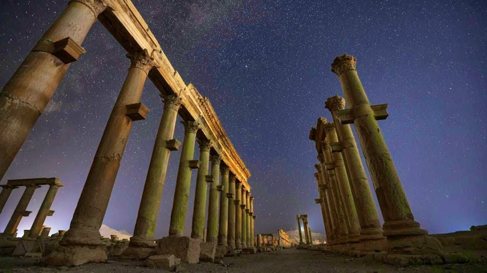ARCHIVE - The ruins of the ancient city of Palmyra under a star-studded sky in the late evening hours. Photo: Ghaith Alsayed/AP/dpa (archive photo)