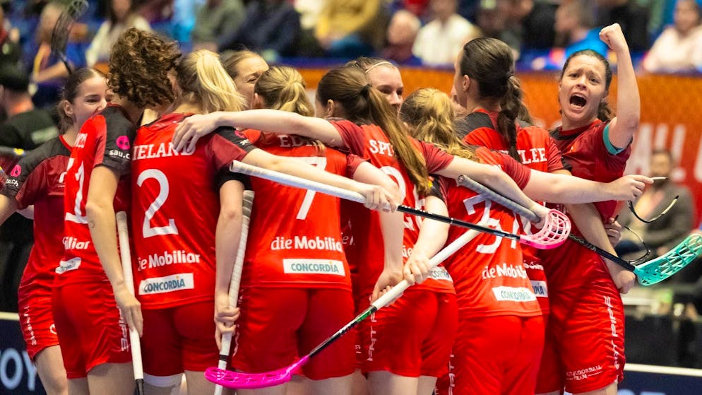The Swiss women cheer, far right, Isabelle Gerig (17, Switzerland) in the final of the floorball world championship.