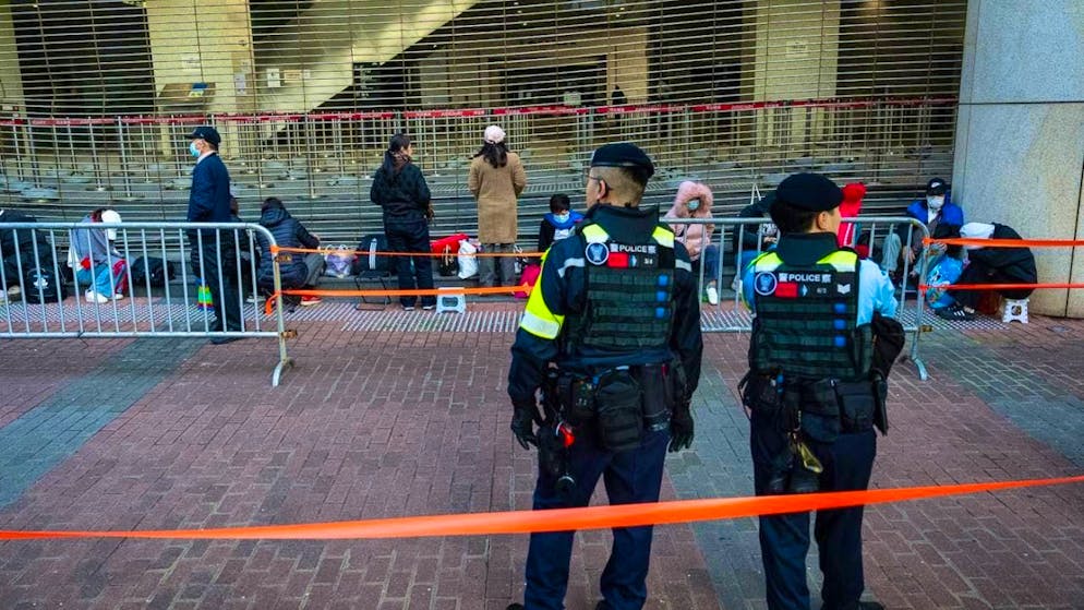 People wait outside the West Kowloon Magistrates' Courts for the verdict in the trial of Hong Kong activist and publisher Jimmy Lai in connection with national security in Hong Kong. Photo: Chan Long Hei/AP/dpa