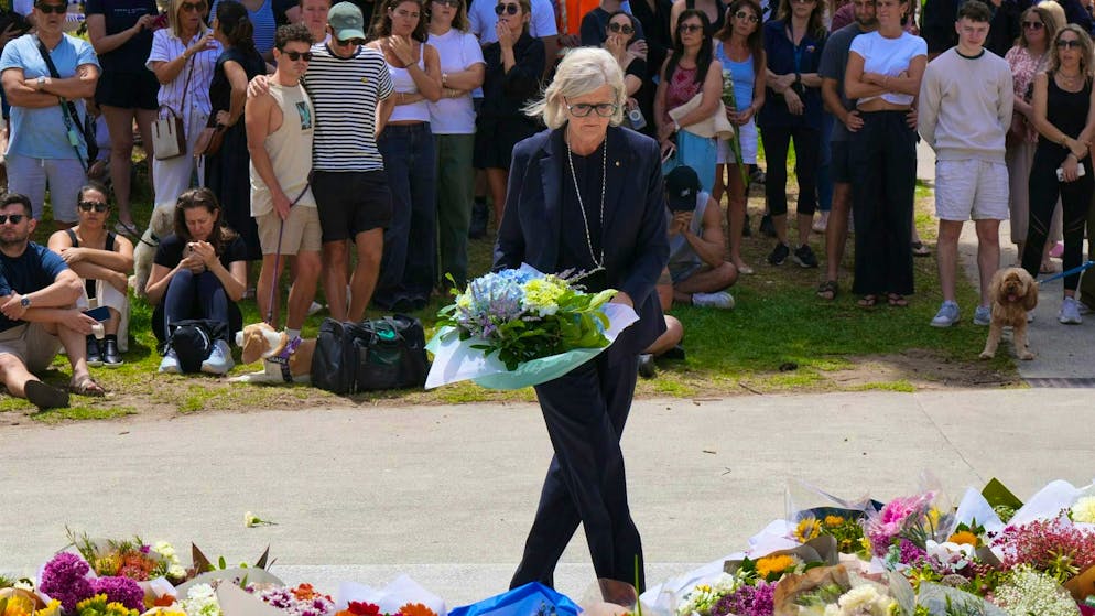 Australia's Governor-General Sam Mostyn lays a bouquet of flowers at Bondi Beach on Monday.