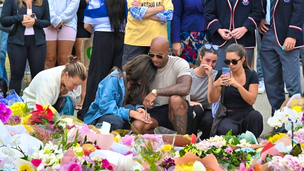 Sydney in a state of shock after the attack - Gallery. People mourn and lay flowers at Bondi Beach