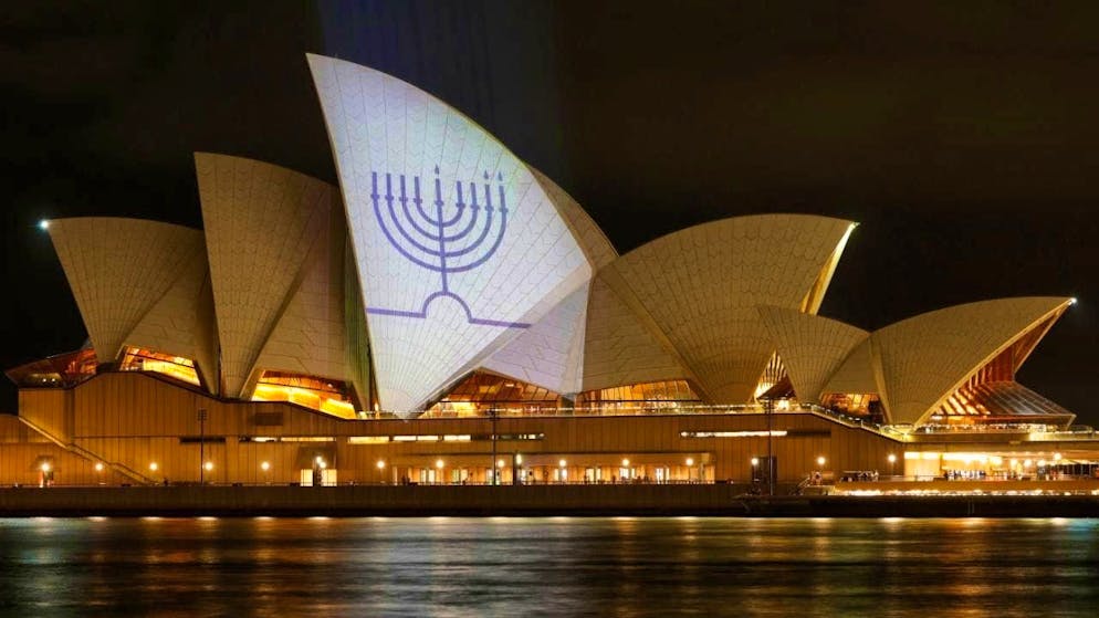 Sydney in a state of shock after the attack - Gallery. A Jewish candlestick lights up at the Sydney Opera House.