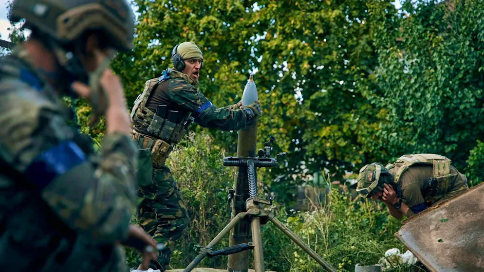 Ukrainian soldiers fire a mortar in the city of Kupyansk in the Kharkiv region.
