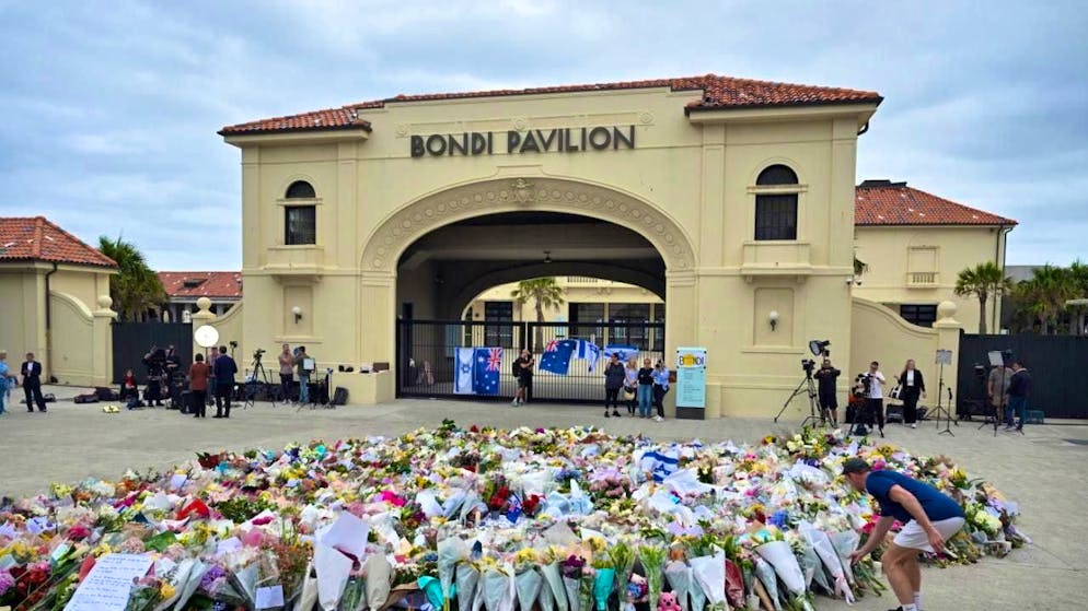 Sydney in a state of shock after the attack - Gallery. The people of Sydney lay flowers on Bondi Beach.