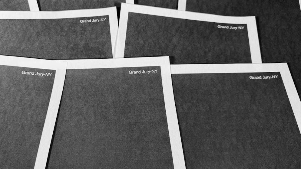 Pages from a completely redacted New York grand jury file on Jeffrey Epstein and Ghislaine Maxwell, released by the U.S. Department of Justice, are photographed in Washington, Friday, Dec. 19, 2025. Photo: Jon Elswick/AP/dpa