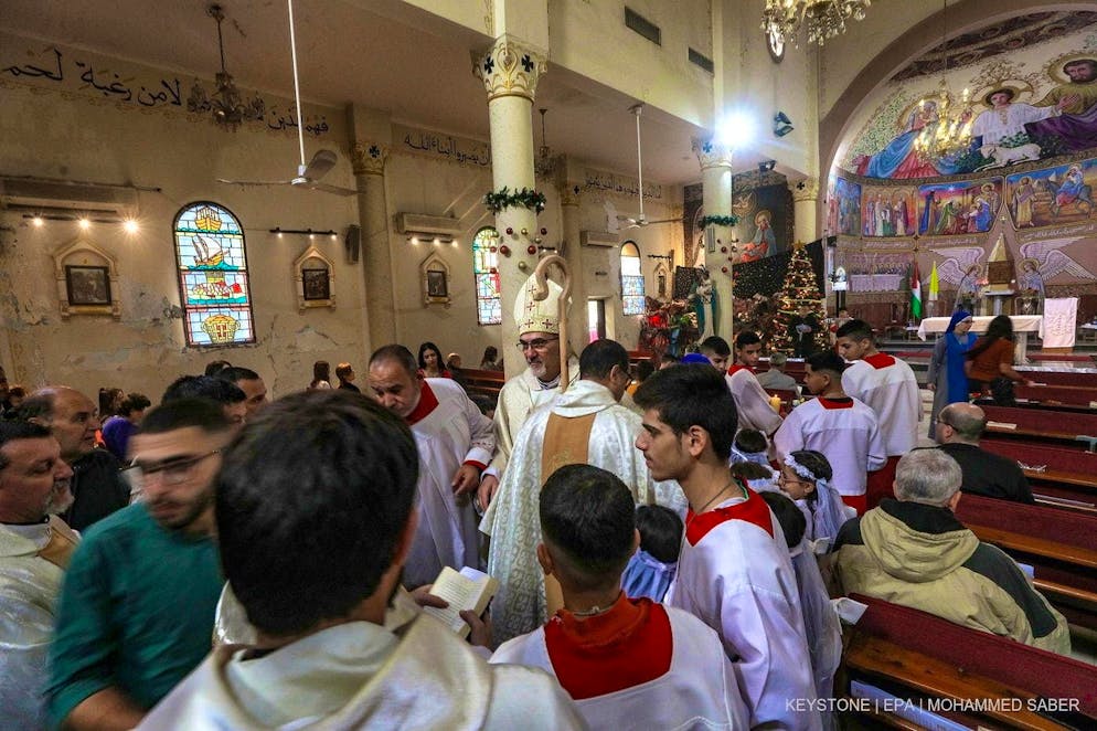 The Latin Patriarch of Jerusalem, Cardinal Pierbattista Pizzaballa (center), arrives at the Latin Church in Gaza City on the Sunday before Christmas.