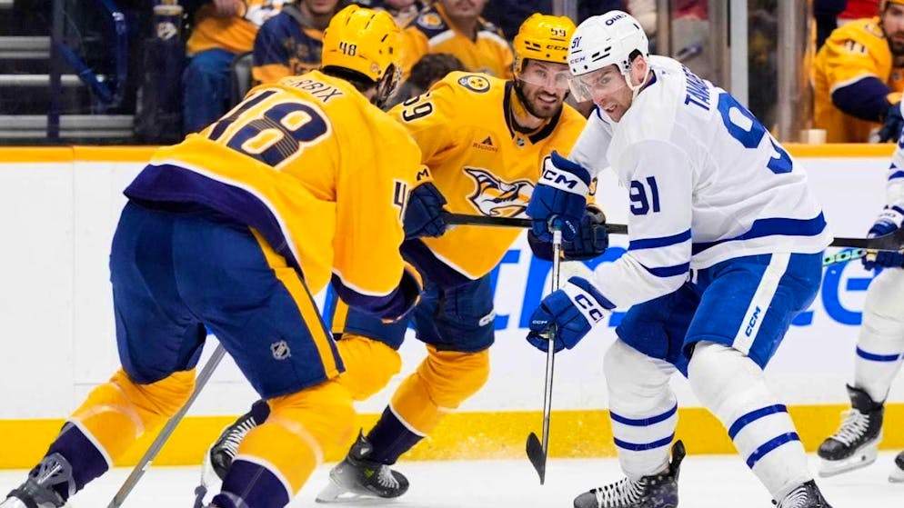 Successful: Roman Josi (center) battles for the puck with Toronto's star forward John Tavares (right).