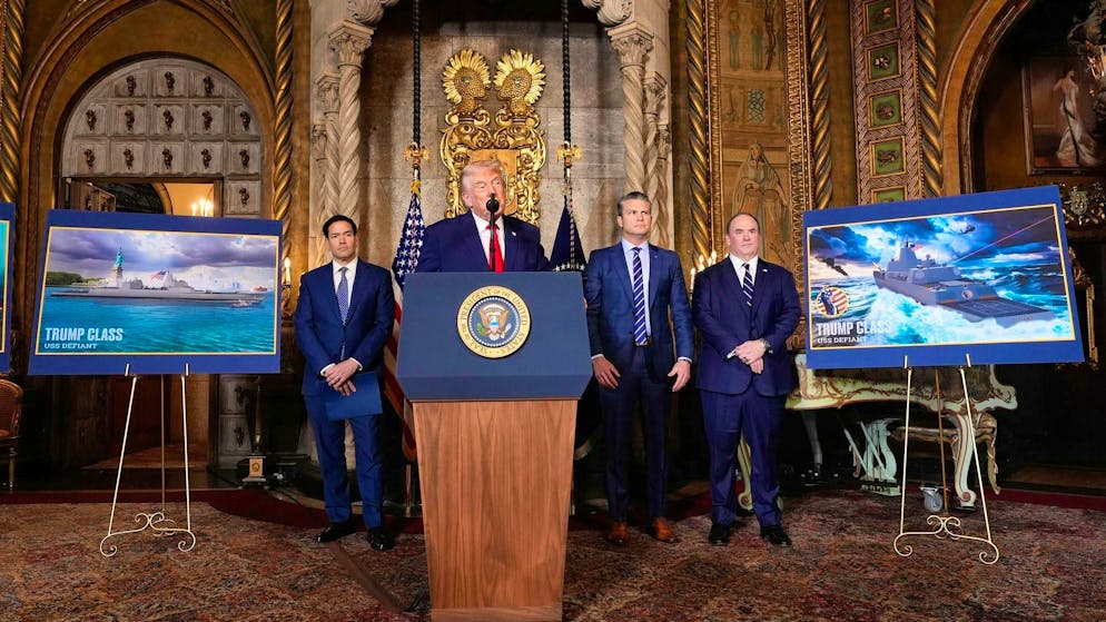 Trump announces construction of new battleships - Gallery. US President Donald Trump (2nd from left) at the announcement in Palm Beach - behind him (from left to right) US Secretary of State Marco Rubio, Secretary of Defense Pete Hegseth and Secretary of the Navy John Phelan.