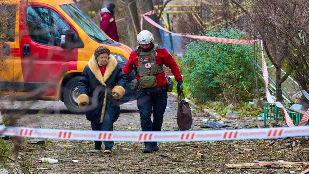A paramedic evacuates an elderly resident after a Russian drone hit a residential building. Photo: Efrem Lukatsky/AP/dpa/Archive