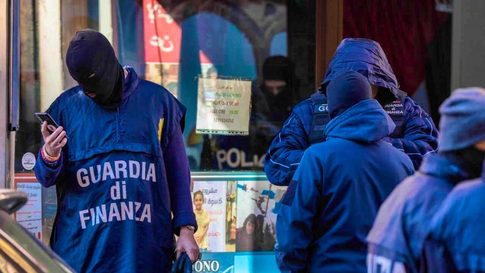 Police officers inspect an alleged charity supporting Palestinian civilians. Photo: Claudio Furlan/LaPresse via AP/dpa - ATTENTION: For editorial use only and only with full attribution of the above credit