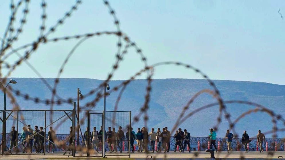 ARCHIVE - Migrants rescued south of Crete are seen after arriving at the port of Lavrio. The Greek government wants to tighten its migration policy: People who are in Greece illegally and do not want to leave are to face at least three years in prison in future. Photo: Petros Giannakouris/AP/dpa